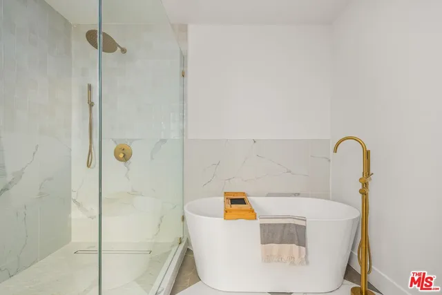 a bath tub sitting next to a white sink