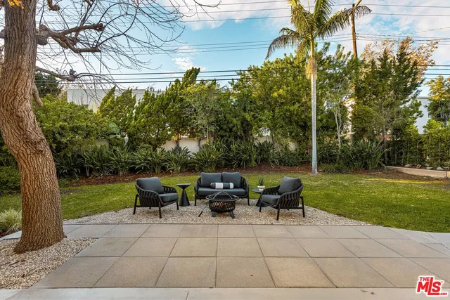 a view of a patio with a table and chairs