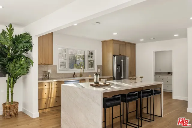 a kitchen with granite countertop a sink and cabinets