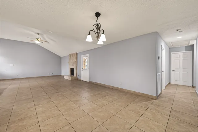 a view of a chandelier fan and entryway