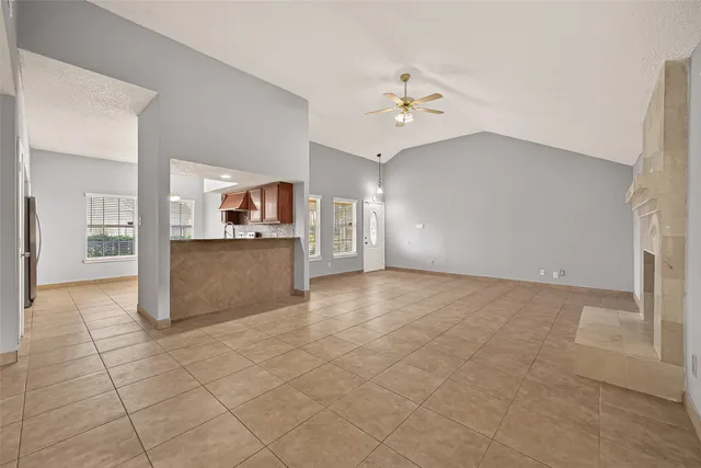 an empty room with kitchen and window