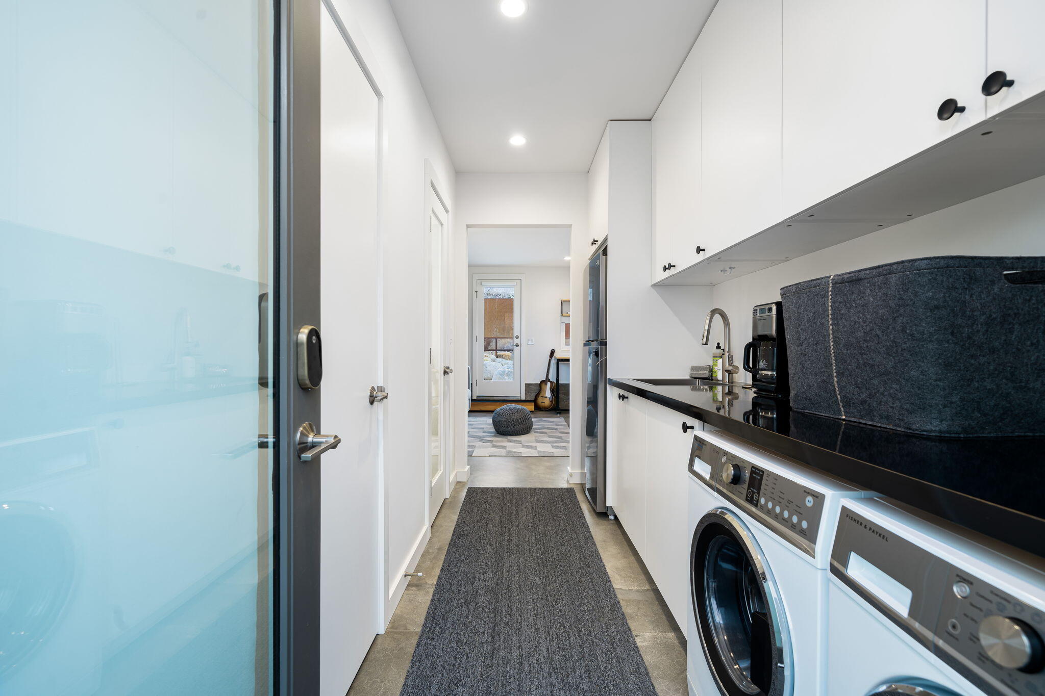 8269 Vía Rocosa Joshua Tree, CA 92252 - Photo 33 of 74 a view of a hallway with washer and dryer