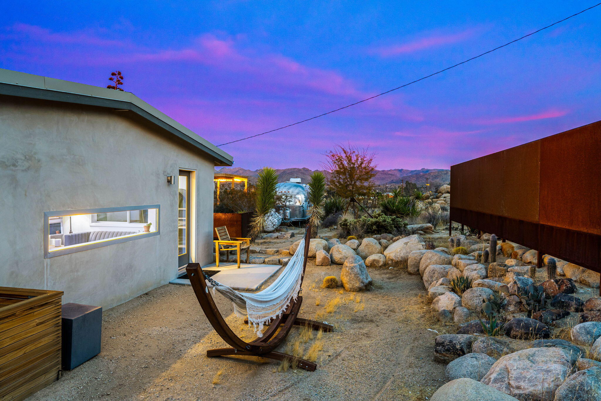 8269 Vía Rocosa Joshua Tree, CA 92252 - Photo 43 of 74 a view of a patio with table and chairs and potted plants