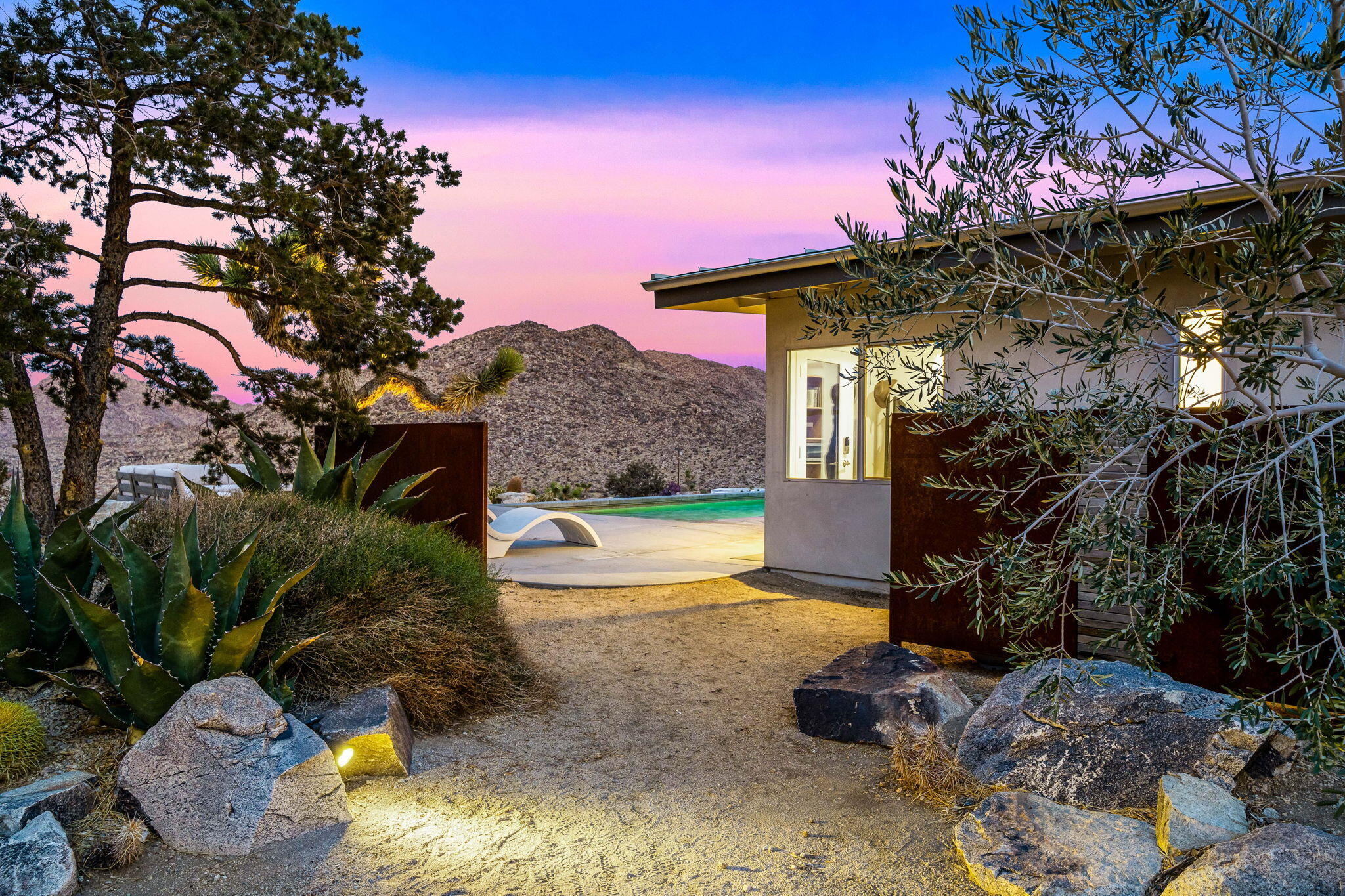 8269 Vía Rocosa Joshua Tree, CA 92252 - Photo 45 of 74 a front view of a house with garden