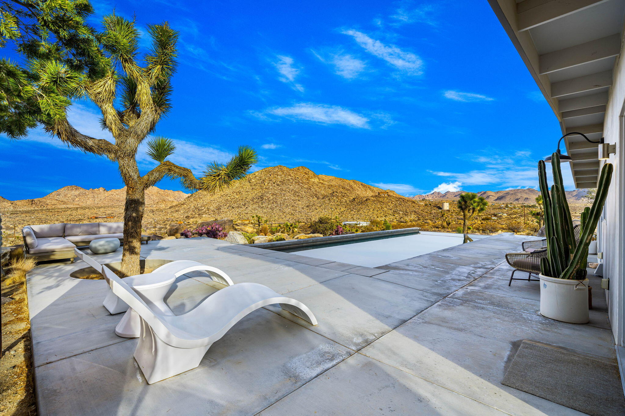 8269 Vía Rocosa Joshua Tree, CA 92252 - Photo 50 of 74 a view of a swimming pool with a patio
