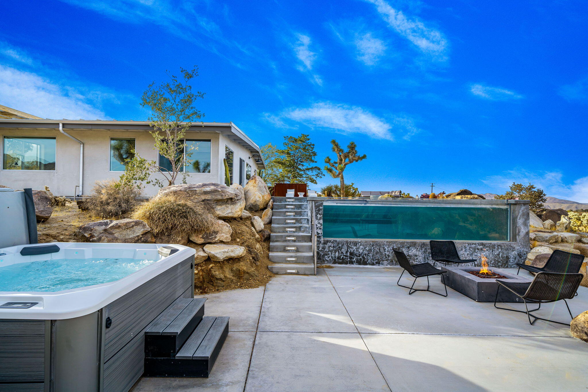 8269 Vía Rocosa Joshua Tree, CA 92252 - Photo 61 of 74 a view of a patio with table and chairs and potted plants