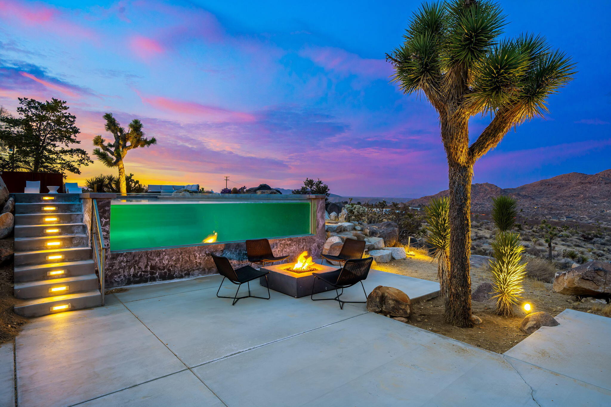 8269 Vía Rocosa Joshua Tree, CA 92252 - Photo 70 of 74 a row of trees and a fire pit with large trees