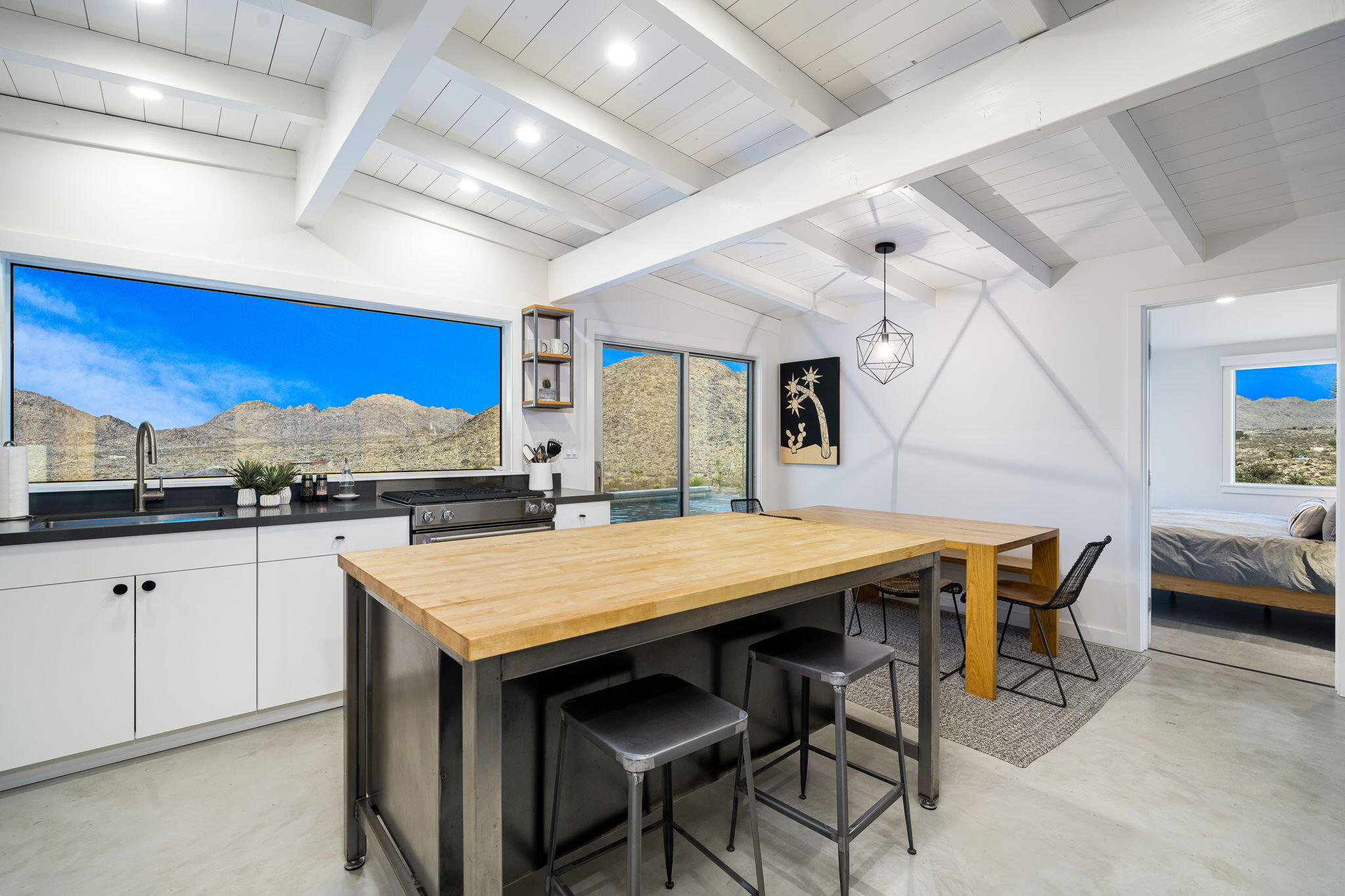 8269 Vía Rocosa Joshua Tree, CA 92252 - Photo 10 of 74 a dining table with chairs and window