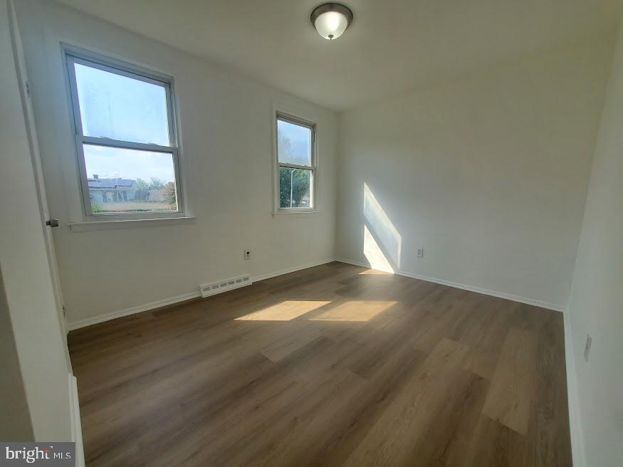 250 Purdue Avenue Pemberton, NJ 08068 - Photo 10 of 23 an empty room with wooden floor and windows