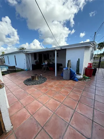 a view of a patio with table and chairs