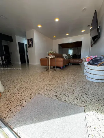 a lobby with a couch and a potted plant