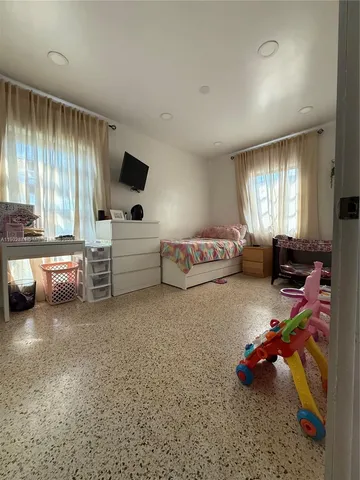 a bedroom with furniture and a flat screen tv