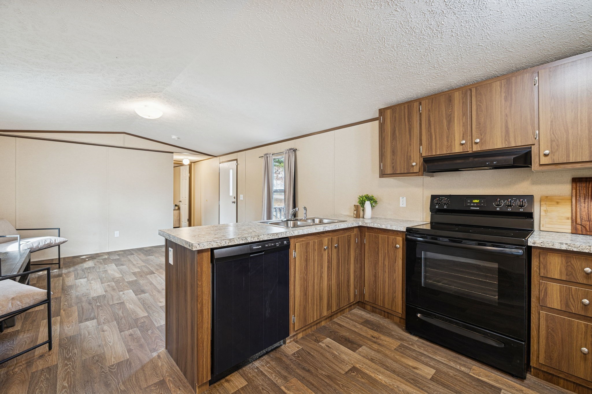 108 Lyell Road Hohenwald, TN 38462 - Photo 7 of 28 a kitchen with stainless steel appliances granite countertop a stove a sink and a refrigerator