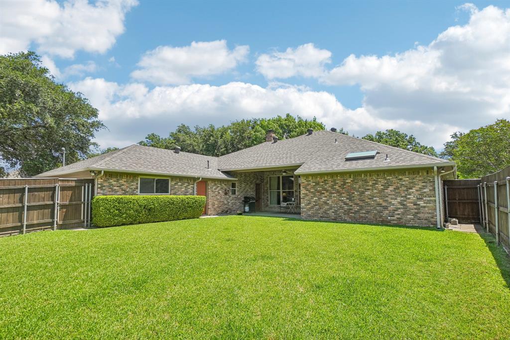 12929 Jasoncrest Trail Dallas, TX 75243 - Photo 34 of 38 Expansive lawn area bordered by a wood privacy fence