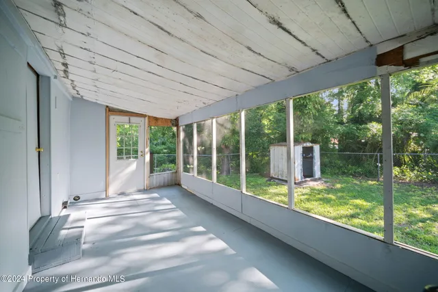 a view of a porch with furniture and garden