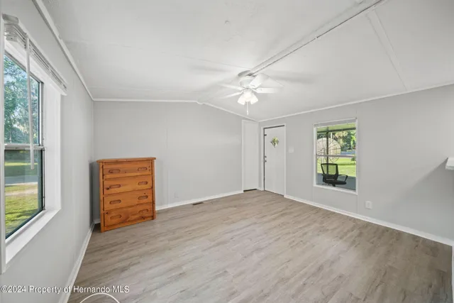 an empty room with windows and closet