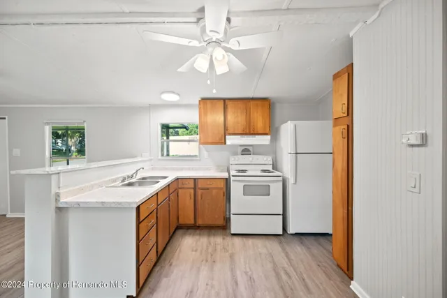 a kitchen with a sink stove and refrigerator