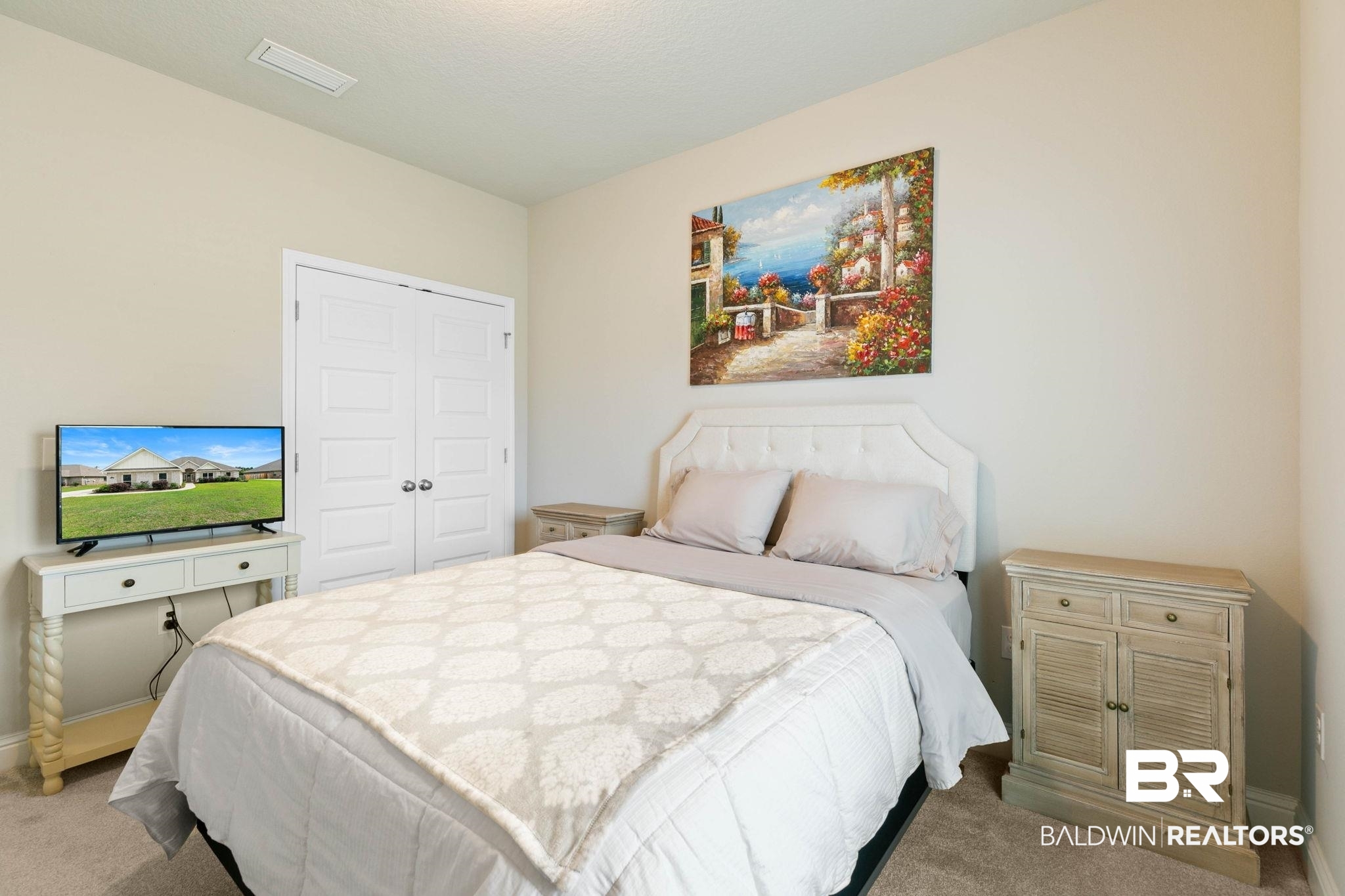 31187 Spoonbill Road Daphne, AL 36527 - Photo 34 of 85 Carpeted room with light-toned walls, featuring a white paneled headboard and a built-in closet with double doors