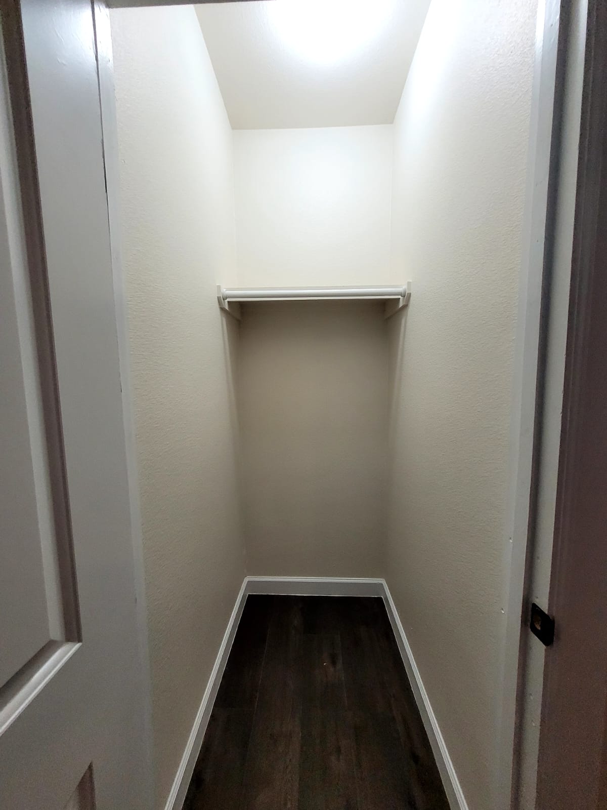 750 South Main Street Lockhart, TX 78644 - Photo 16 of 31 Walk in closet with dark wood-style flooring