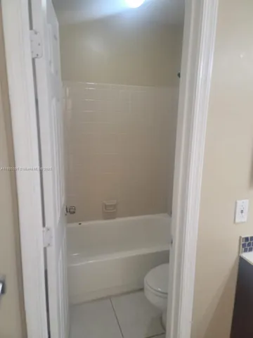 a bathroom with a bathtub and a toilet