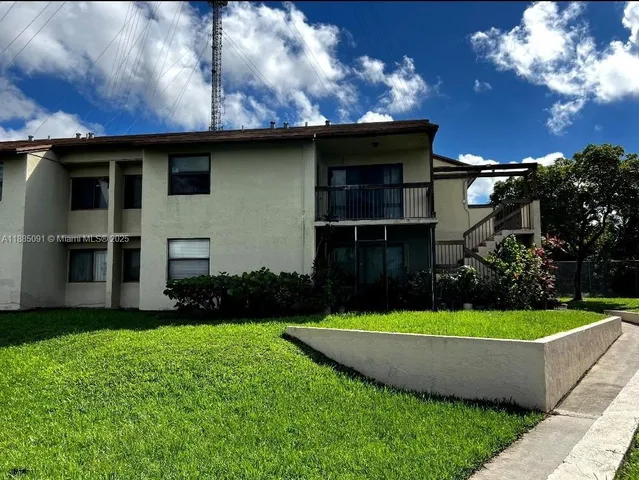 a view of a house with a tub and yard