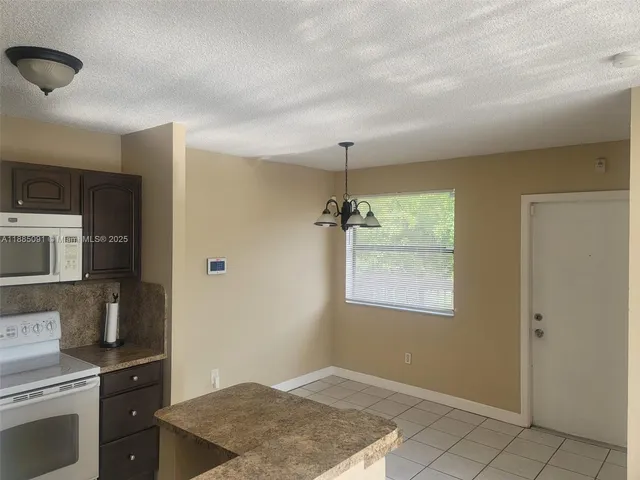 a kitchen with a stove and a refrigerator