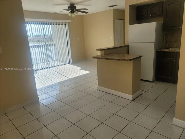 a kitchen with a sink and a refrigerator