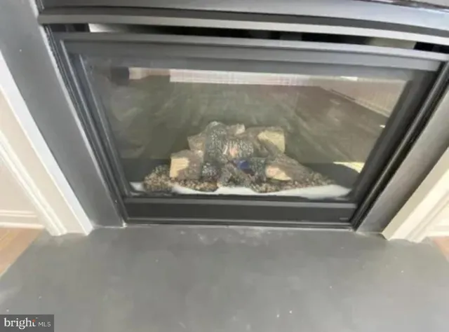 wooden floor fireplace and windows in an empty room