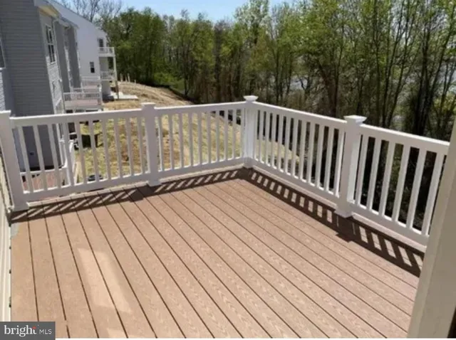 a view of a house with wooden deck