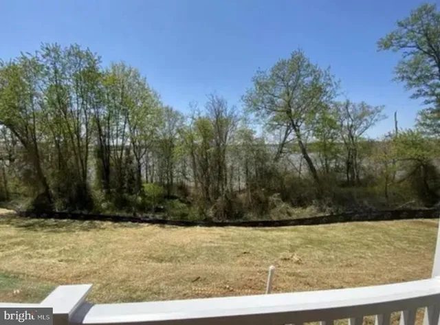 a view of balcony with wooden floor and fence