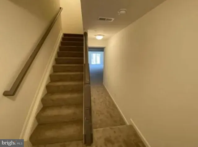 an empty room with a fireplace and a window