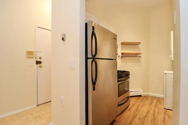 a view of walk in closet with empty racks