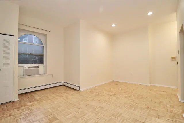 an empty room with a mirror