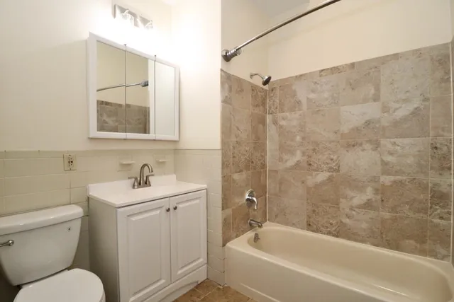 a bathroom with a toilet sink and shower