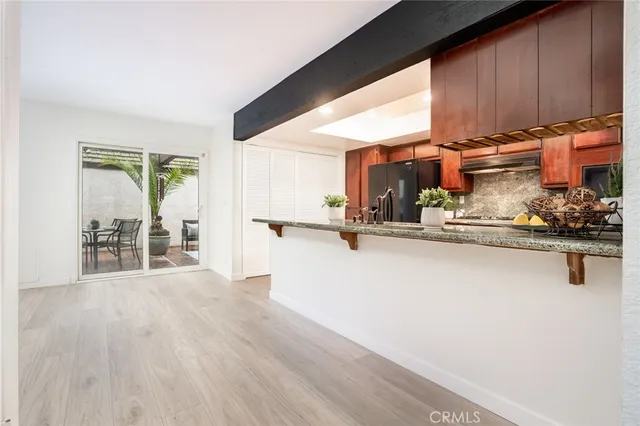a view of a living room hardwood floor and a large window