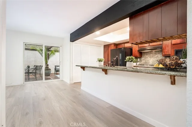 a view of a living room hardwood floor and a large window