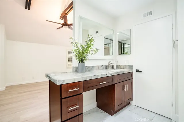 a bathroom with a granite countertop sink a mirror and a