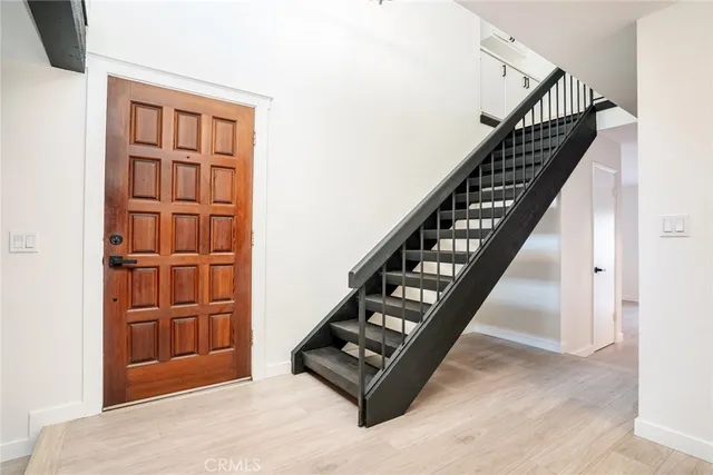 a view of staircase with white walls and windows