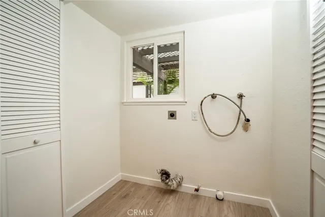 a view of a room with wooden floor and window