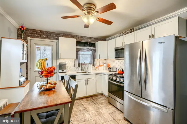 a kitchen with stainless steel appliances a refrigerator a stove a sink dishwasher and a refrigerator