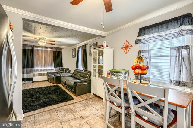 a living room with furniture a rug and a window