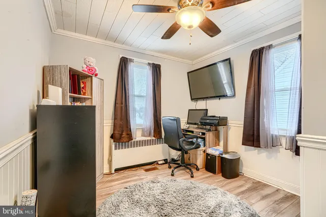 a work room with furniture and a flat screen tv