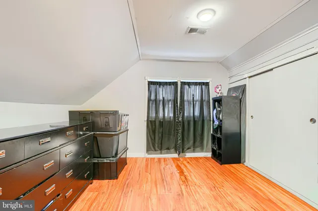 a bedroom with a bed and a mirror