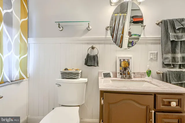 a bathroom with a sink a vanity and a mirror