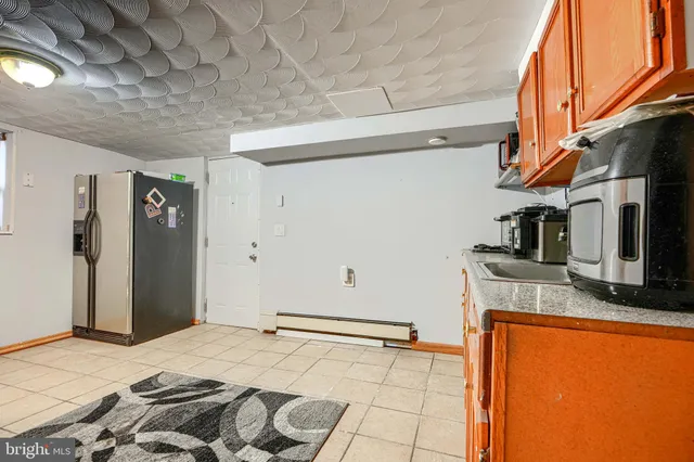a kitchen with stainless steel appliances a sink a stove cabinets and a window