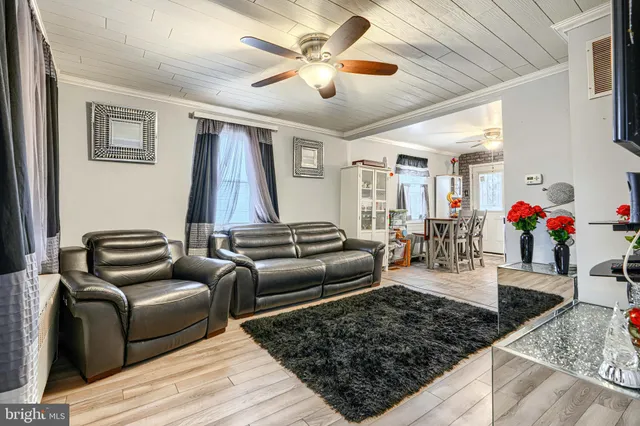 a living room with furniture ceiling fan and a rug