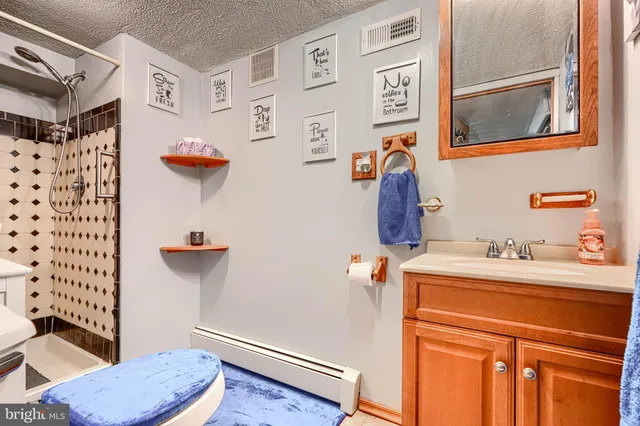 a bathroom with a toilet and a shower curtain