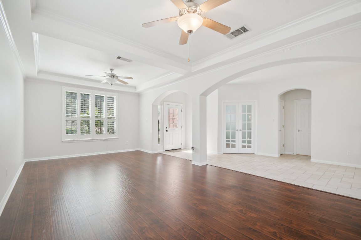 12421 Gun Metal Drive Austin, TX 78739 - Photo 18 of 40 a view of an empty room with wooden floor and a window