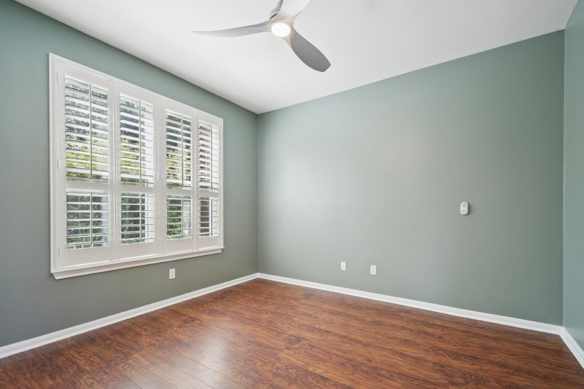 12421 Gun Metal Drive Austin, TX 78739 - Photo 19 of 40 a view of an empty room with wooden floor and a window