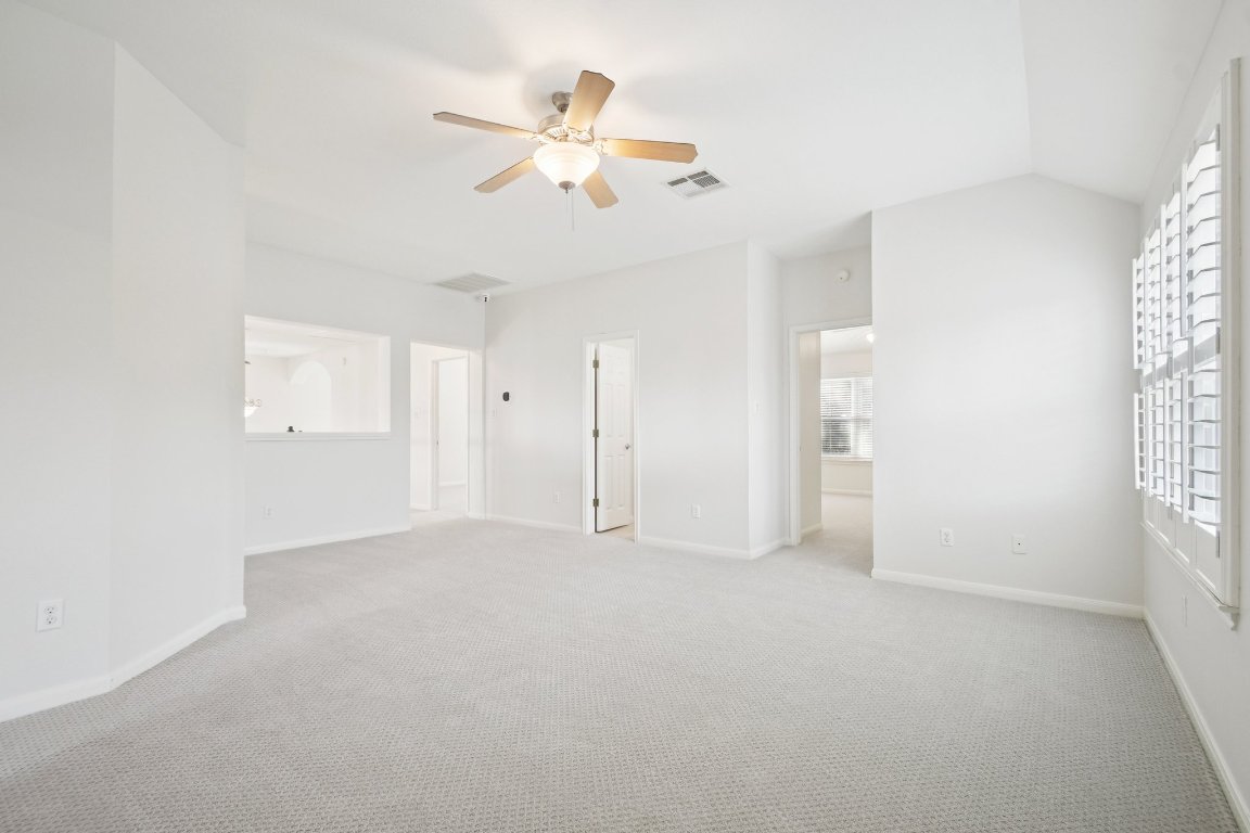 12421 Gun Metal Drive Austin, TX 78739 - Photo 30 of 40 an empty room with windows and fan